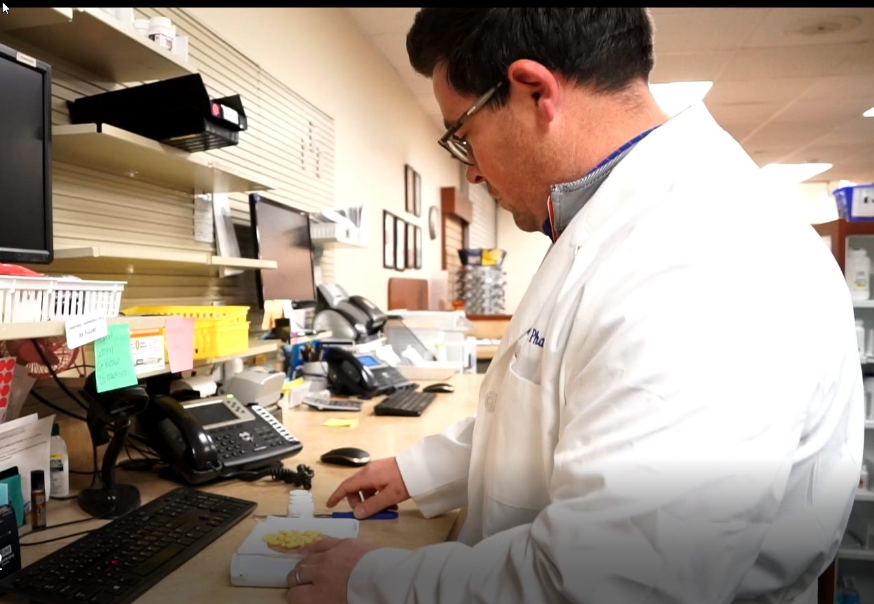 Dr. Hank examines medications in a licensed US pharmacy